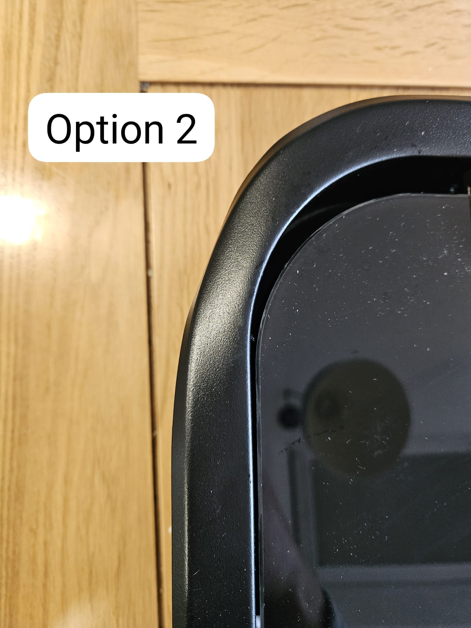 Black campervan window frame edge on wooden surface, labeled Option 2